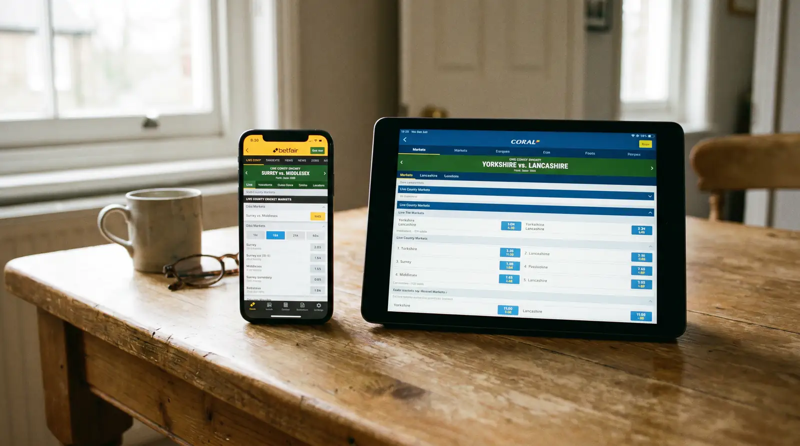 Phone and tablet side by side displaying different bookmaker apps for county cricket