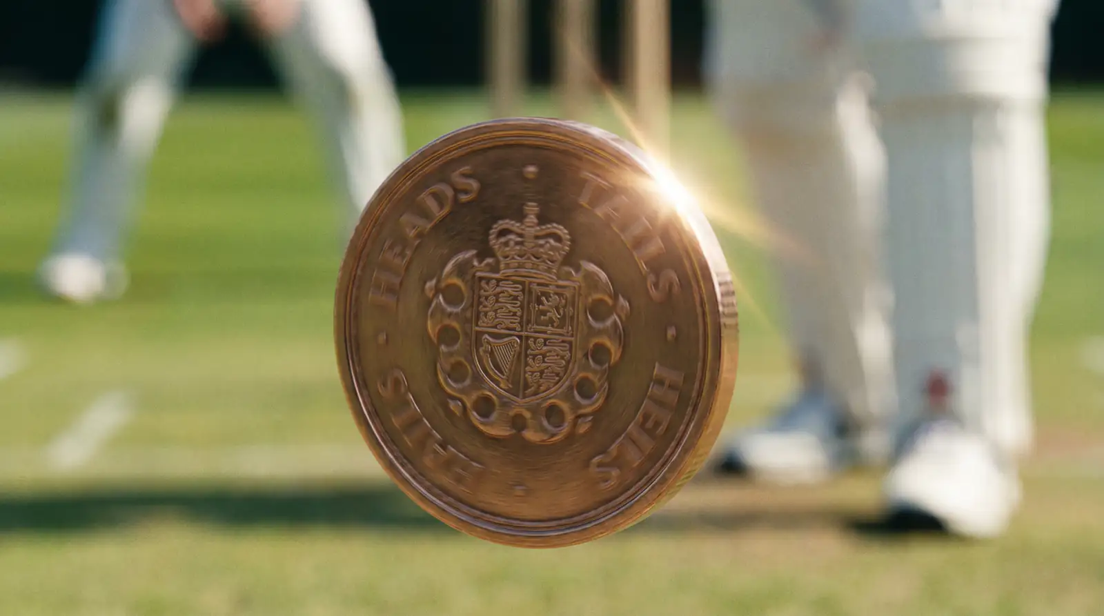 Close-up of a cricket match coin being flipped in the air at the toss