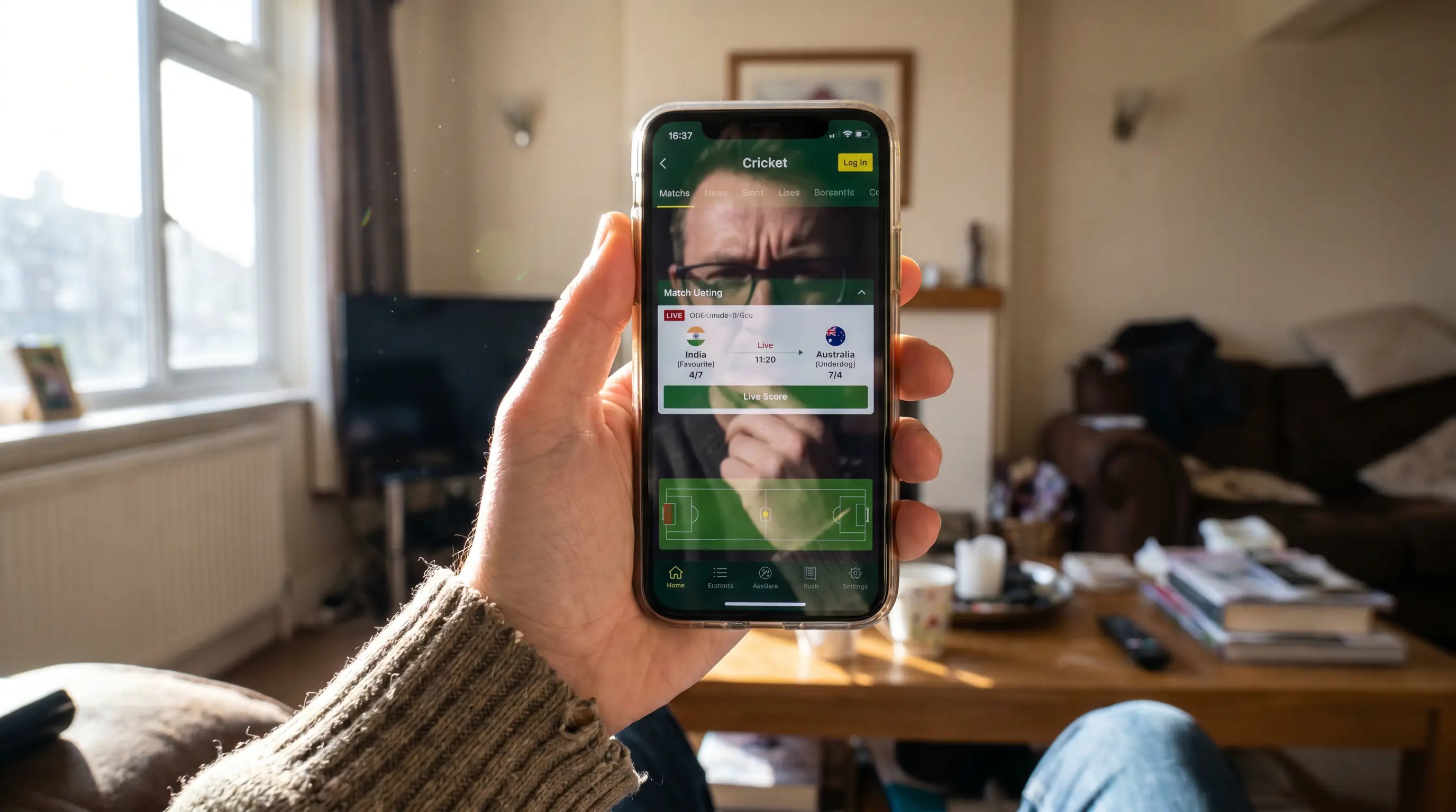 Person looking at a phone screen comparing odds-on and odds-against cricket prices
