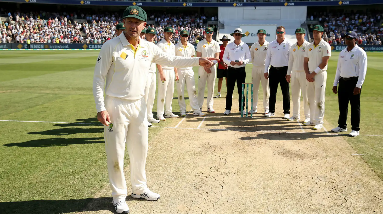 Cricket team celebrating after winning the toss and choosing to bat on a flat pitch