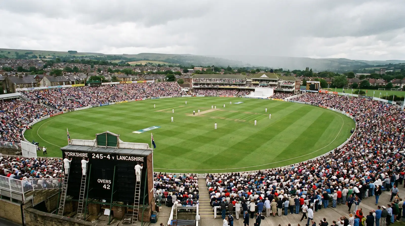 Aerial view of a packed cricket ground in England with green outfield and spectators filling the stands