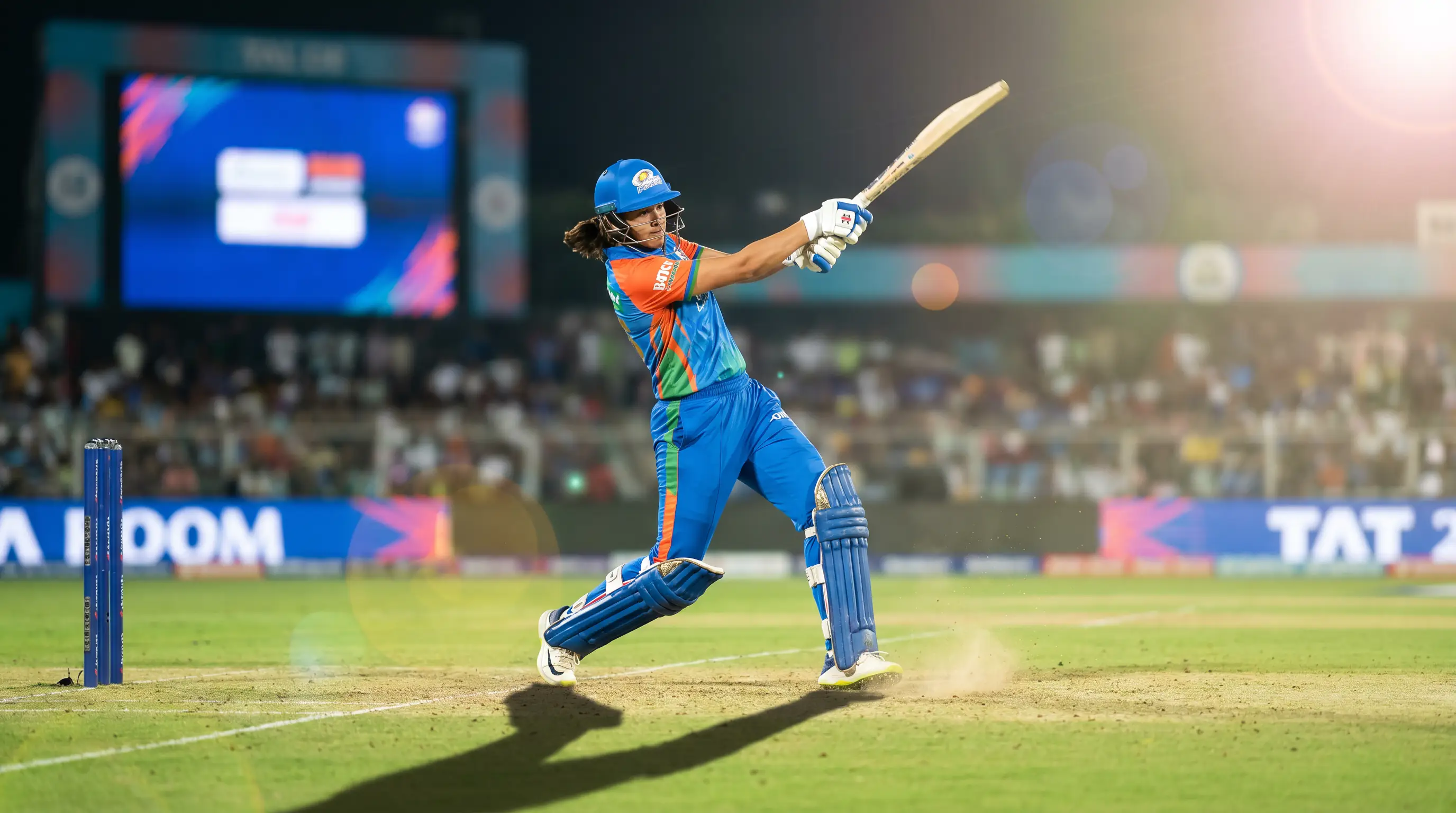 Women's cricket player batting during a T20 match with market options displayed